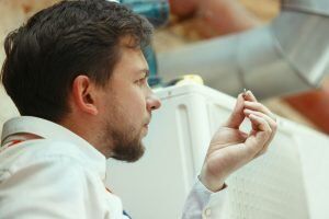 Blog 27 hvac technician working capacitor part condensing unit male worker repairman uniform repairing adjusting conditioning system diagnosing looking technical issues